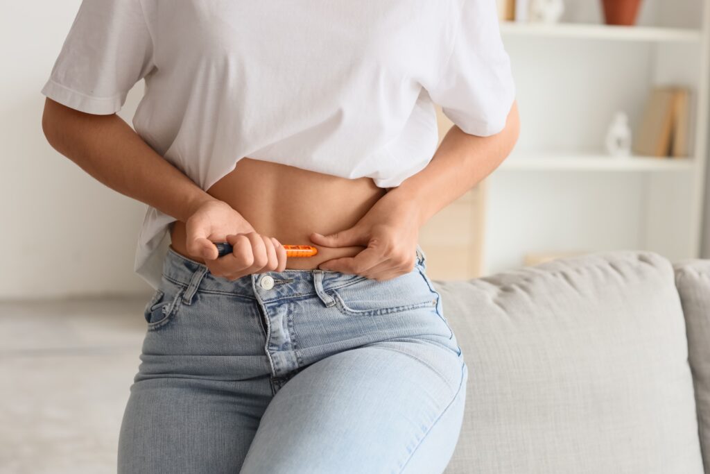Woman injecting herself with hormones