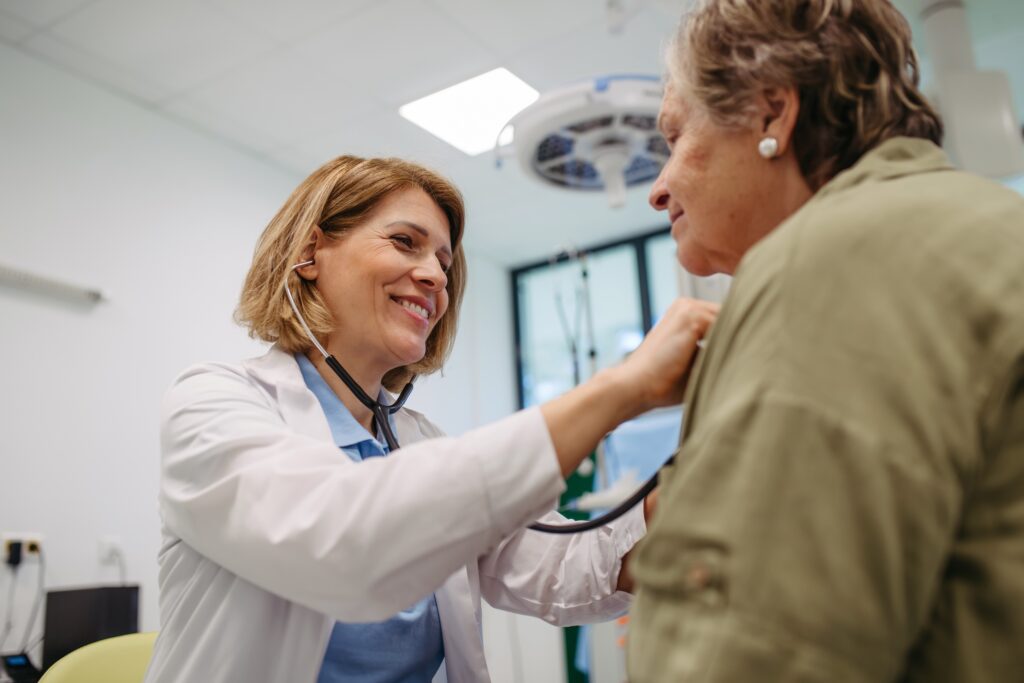 doctor examining patient with stethoscope